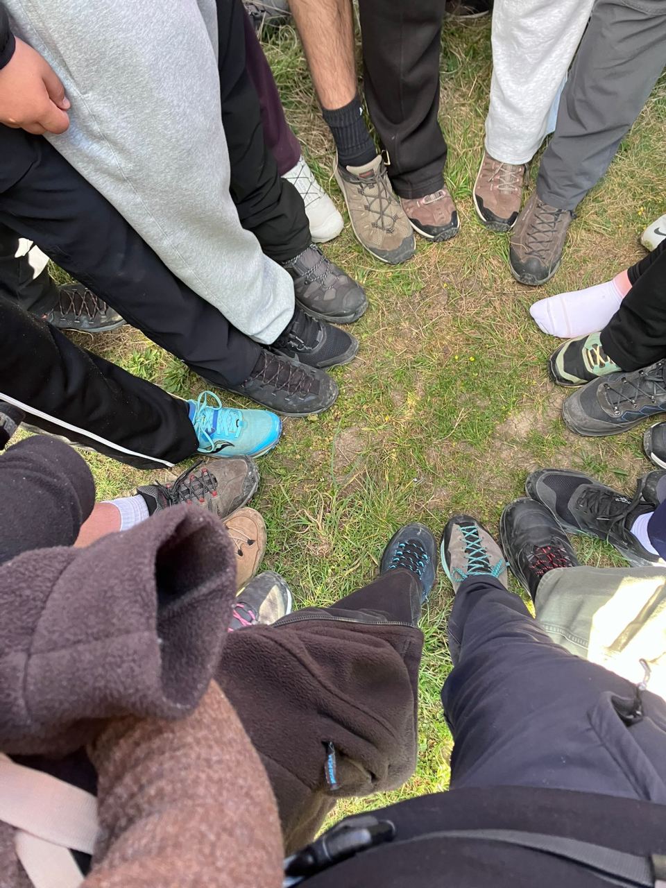 Cercle de cohésion en extérieur, baskets dans l'herbe